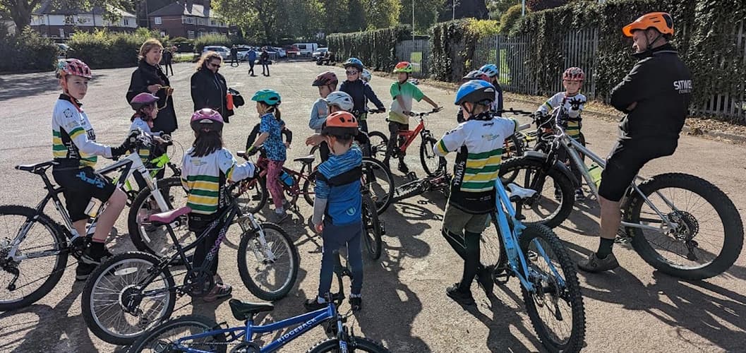 A photograph of our Go-Ride coaching group listneing to intructions from a mix of club coaches